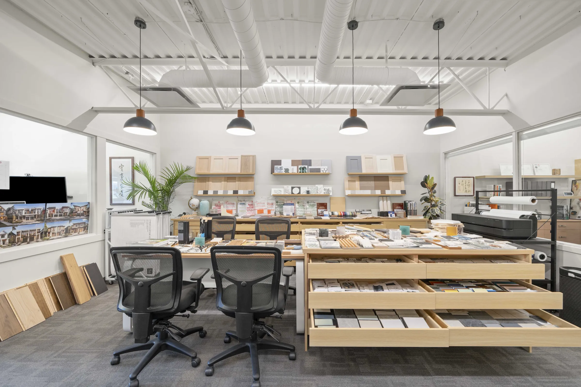 Rely Construction's Richmond studio: the sample wall, and the selection table with its drawers pulled open